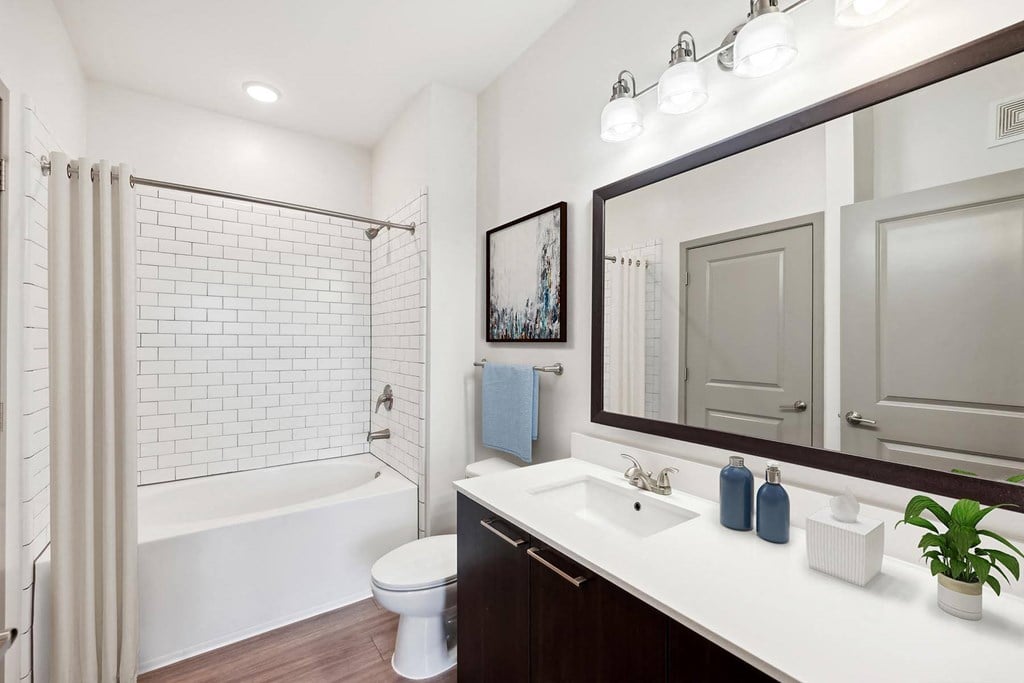 a bathroom with a sink and a shower and a toilet at Glenwood at Grant Park Apartments, Atlanta, GA, 30316